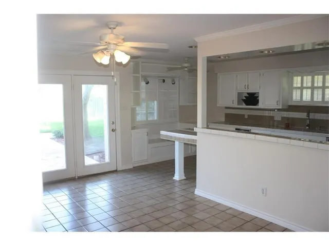 a living room with kitchen island granite countertop furniture and a fireplace