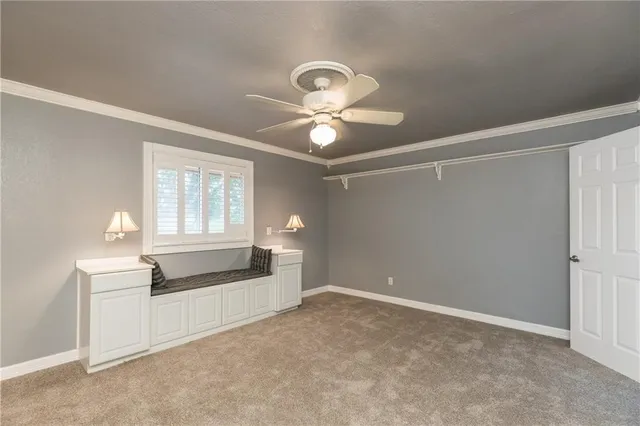 a living room with furniture and a ceiling fan