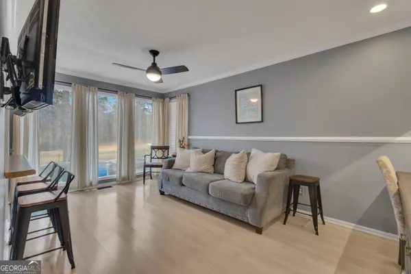 a bedroom with furniture and a flat screen tv