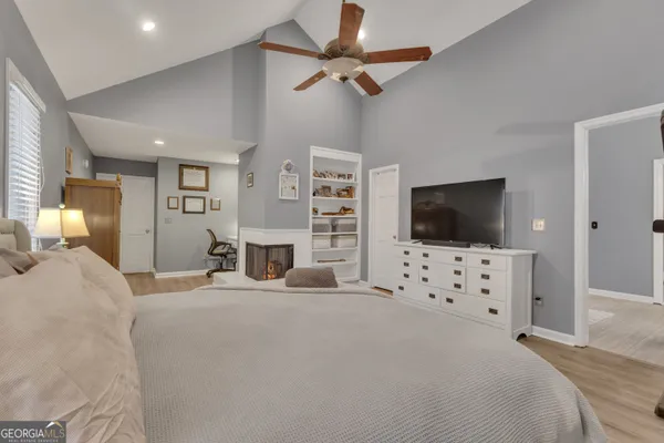 a bedroom with a bed and a ceiling fan