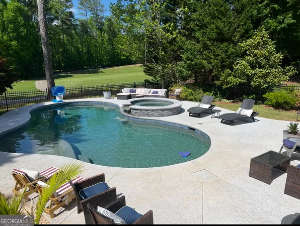 a view of a swimming pool with a patio