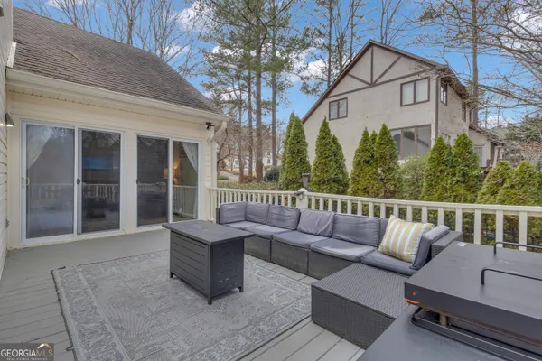 a view of a patio with table and chairs with wooden fence and plants