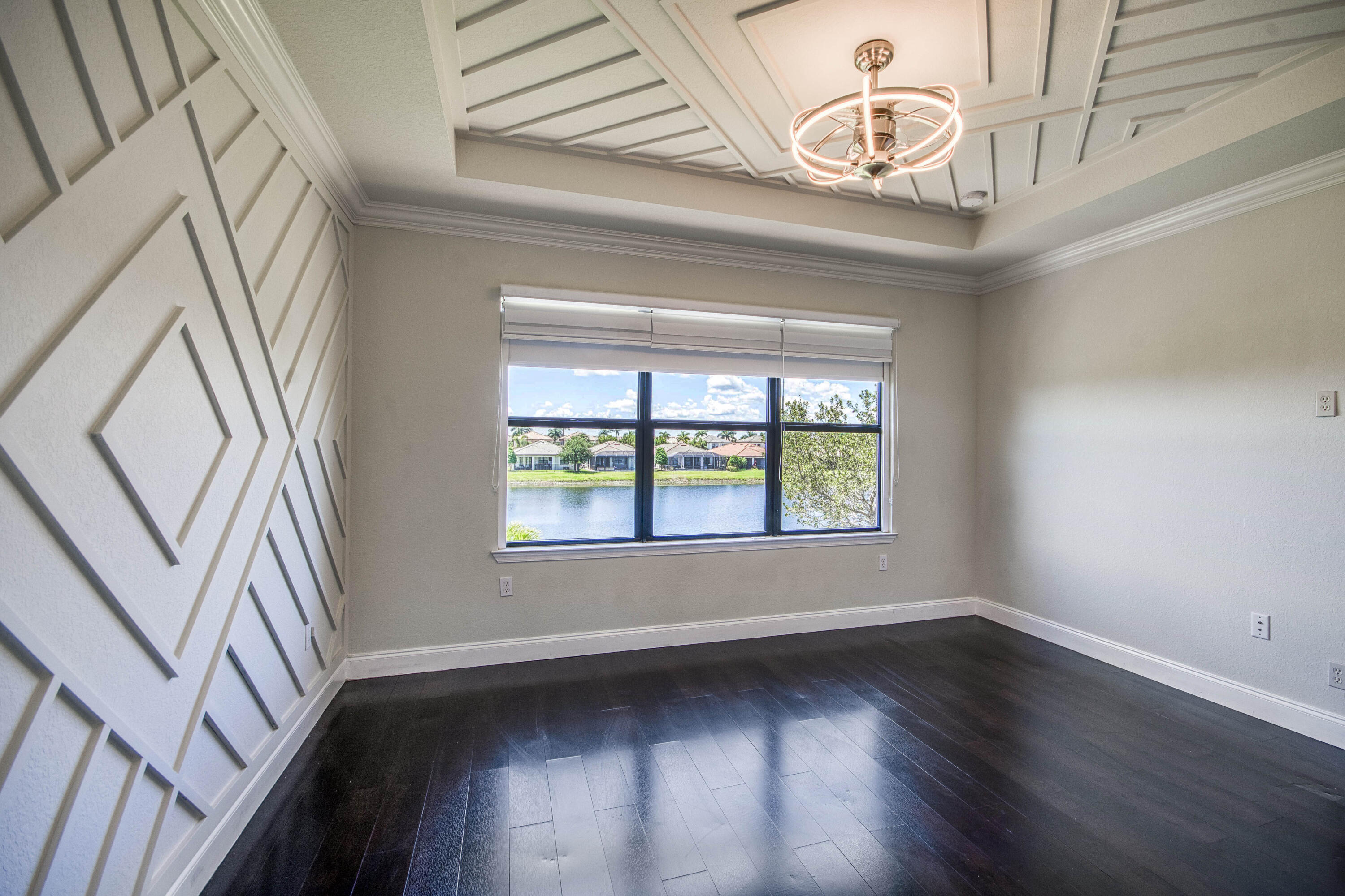 8301 Rearing Lane Lake Worth, FL 33467 - Photo 22 of 33 an empty room with wooden floor fan and windows