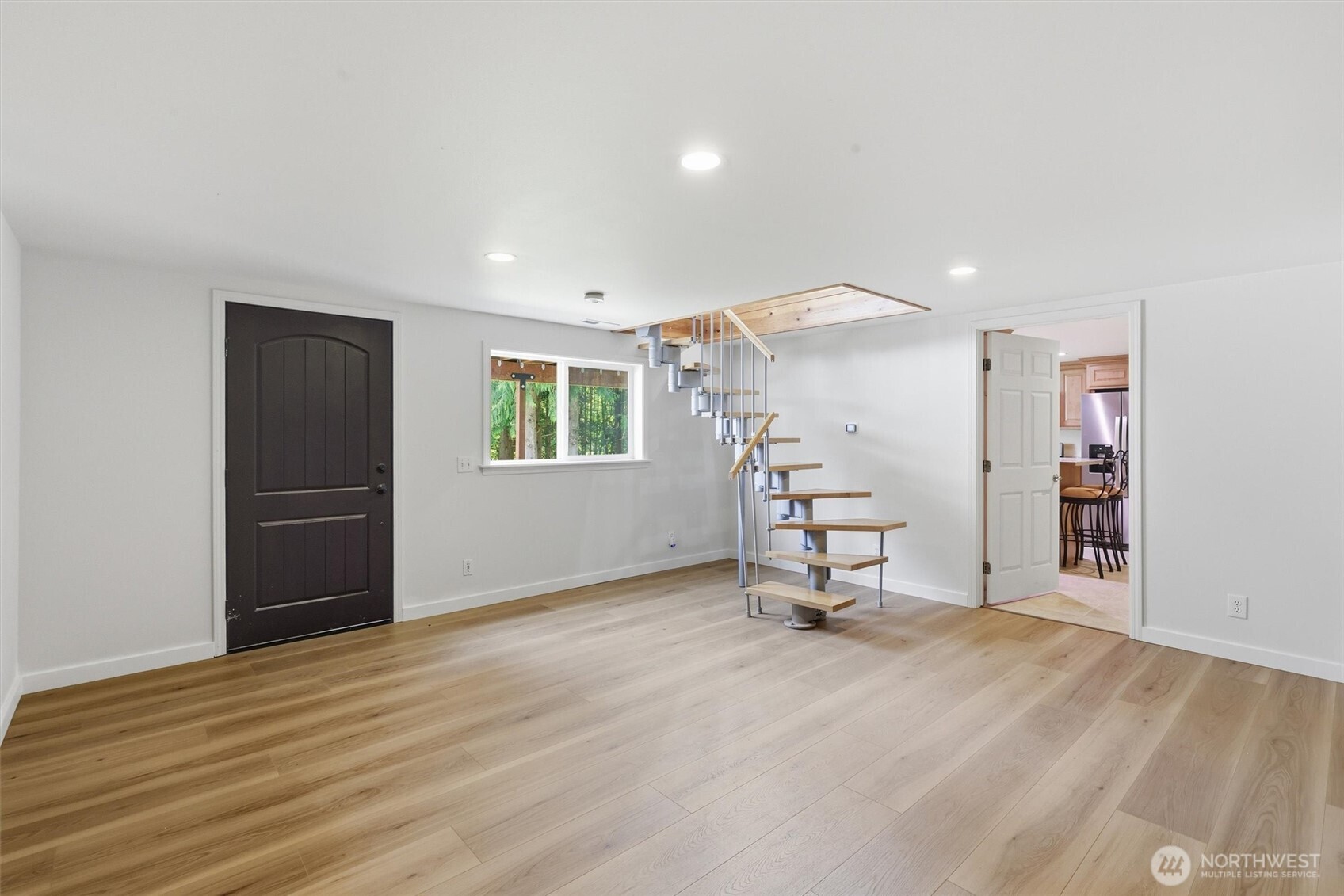 5523 East Wishon Road Snohomish, WA 98290 - Photo 27 of 39 a view of a room with a wooden floor and a ceiling fan