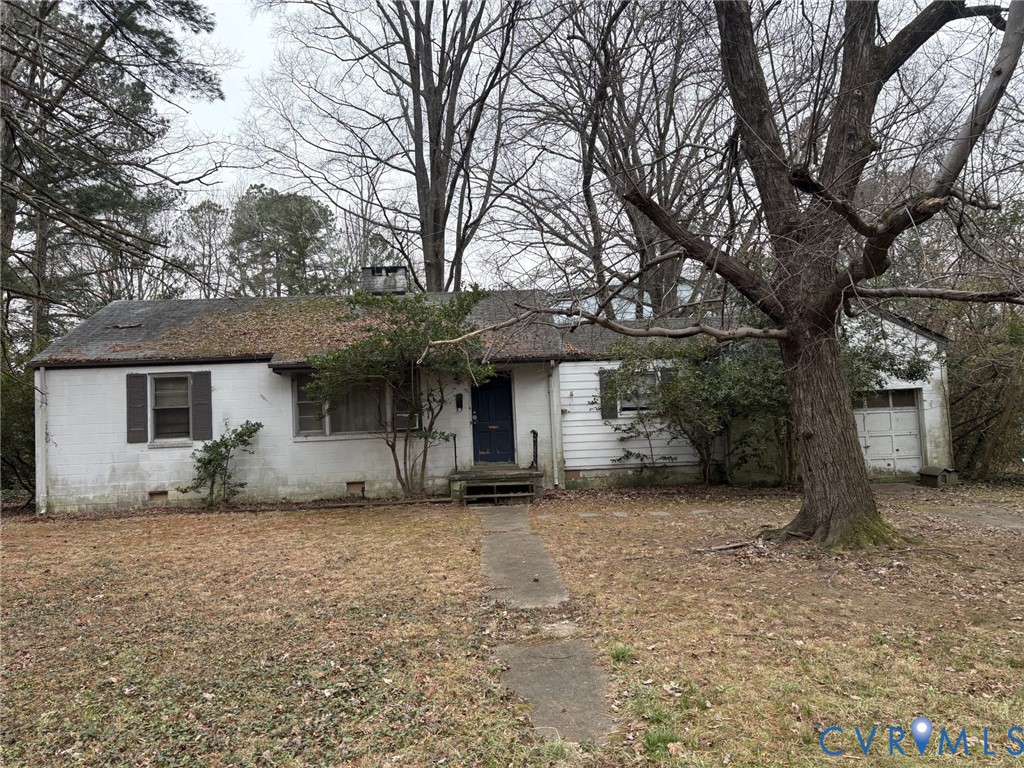 a view of a house with a tree and a garage