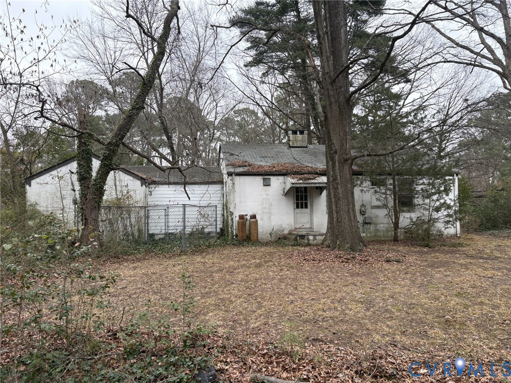 1208 Leicester Road Richmond, VA 23225 - Photo 2 of 9 a view of a backyard that has large trees and a large tree