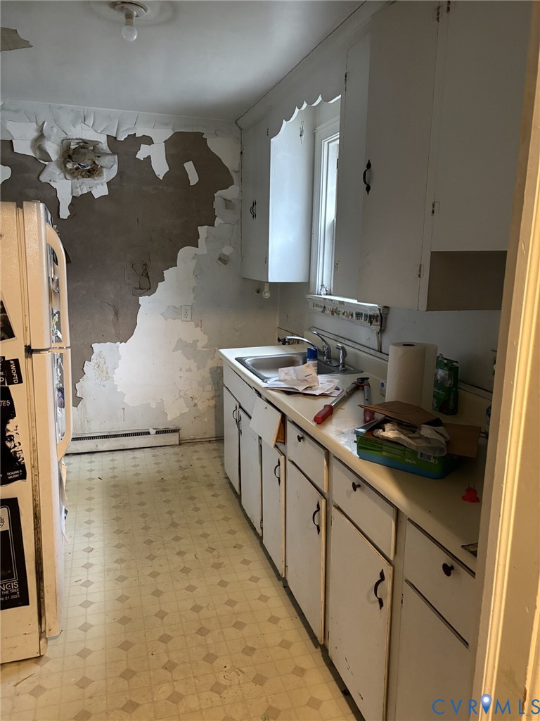 1208 Leicester Road Richmond, VA 23225 - Photo 3 of 9 a kitchen with sink cabinets and stove