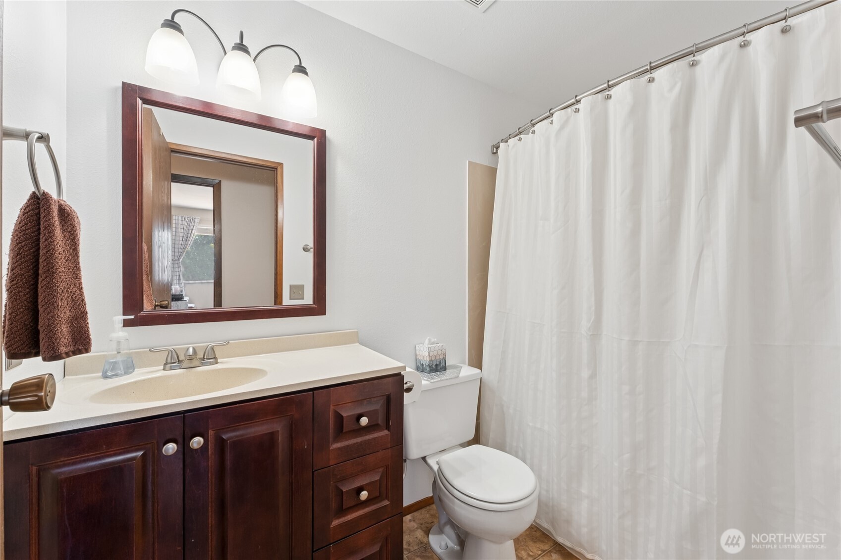 2402 Southeast 21st Street Renton, WA 98055 - Photo 9 of 24 a bathroom with a sink vanity mirror and toilet
