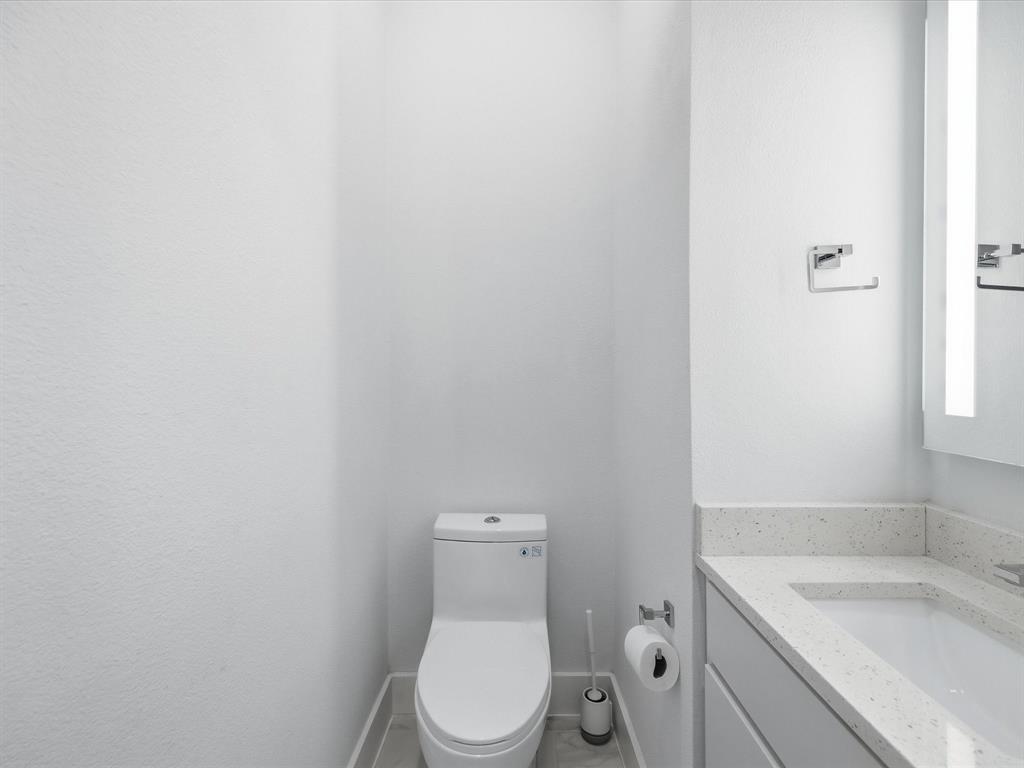 1920 Dowgate Court Dallas, TX 75204 - Photo 20 of 38 Half bathroom with vanity and toilet
