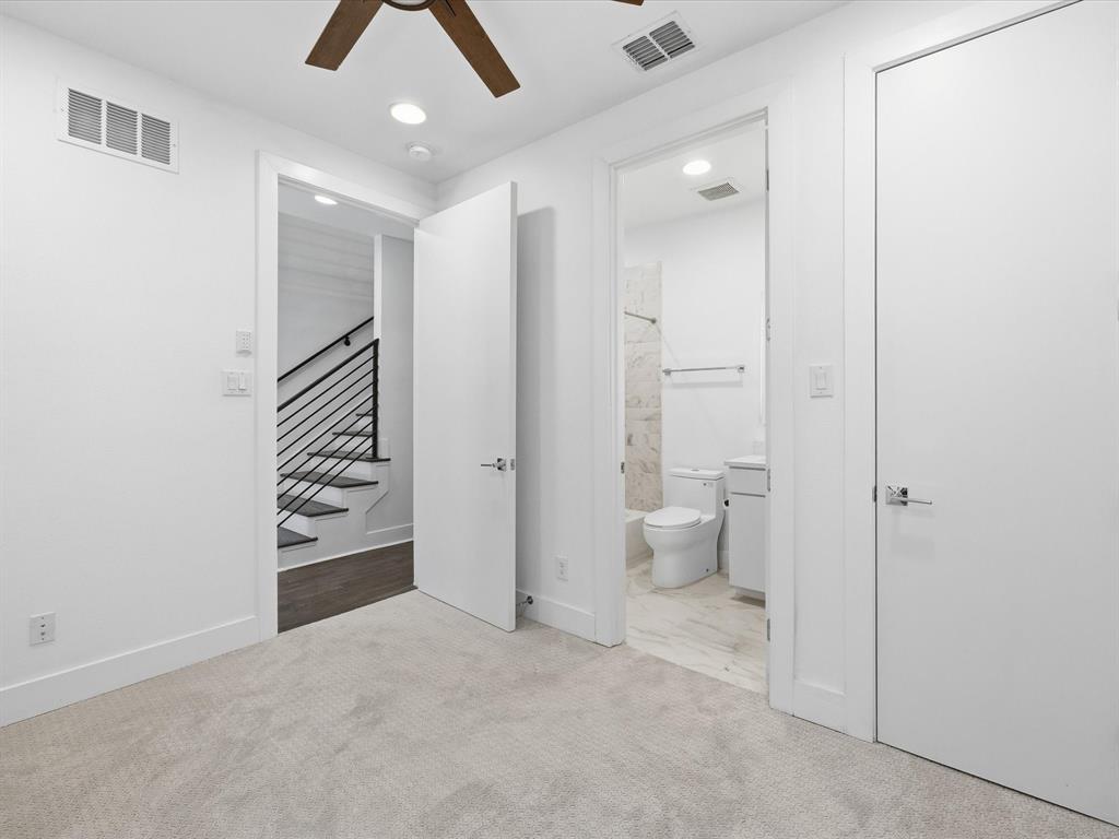 1920 Dowgate Court Dallas, TX 75204 - Photo 22 of 38 Unfurnished bedroom with ceiling fan, light colored carpet, recessed lighting, and ensuite bath