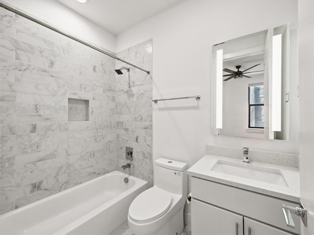 1920 Dowgate Court Dallas, TX 75204 - Photo 23 of 38 Full bath featuring vanity, washtub / shower combination, ceiling fan, and recessed lighting
