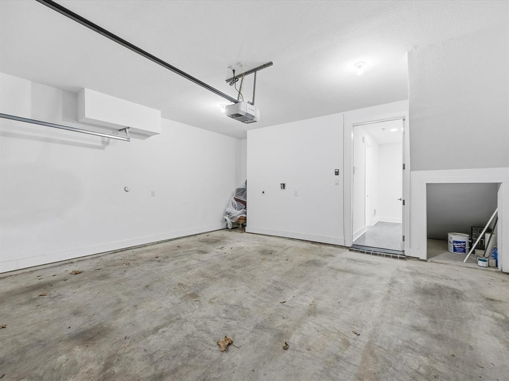 1920 Dowgate Court Dallas, TX 75204 - Photo 28 of 38 Garage featuring a garage door opener