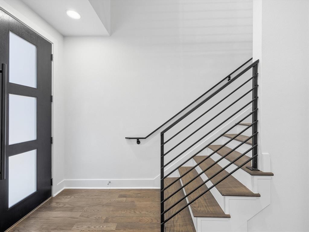 1920 Dowgate Court Dallas, TX 75204 - Photo 3 of 38 Foyer entrance featuring dark wood finished floors and baseboards