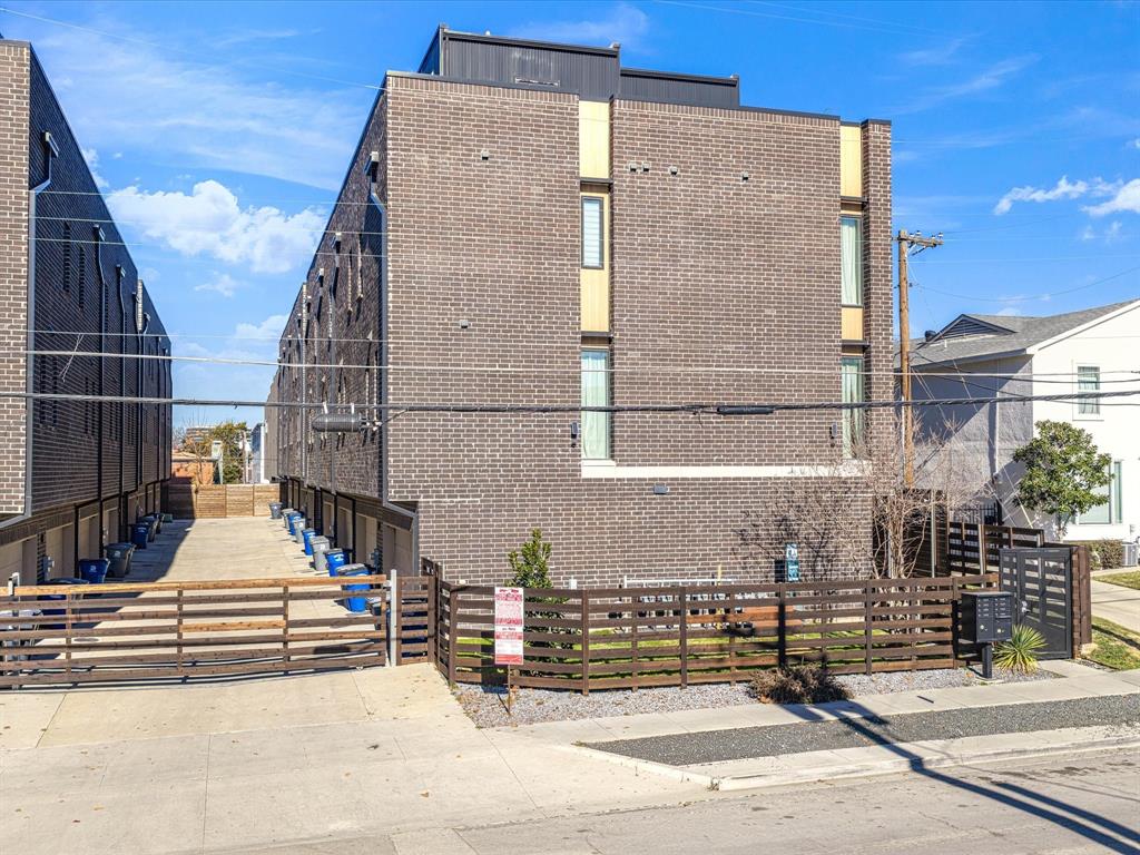 1920 Dowgate Court Dallas, TX 75204 - Photo 30 of 38 View of side of property featuring brick siding and a fenced front yard