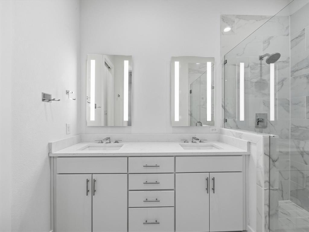 1920 Dowgate Court Dallas, TX 75204 - Photo 8 of 38 Bathroom featuring a marble finish shower and double vanity