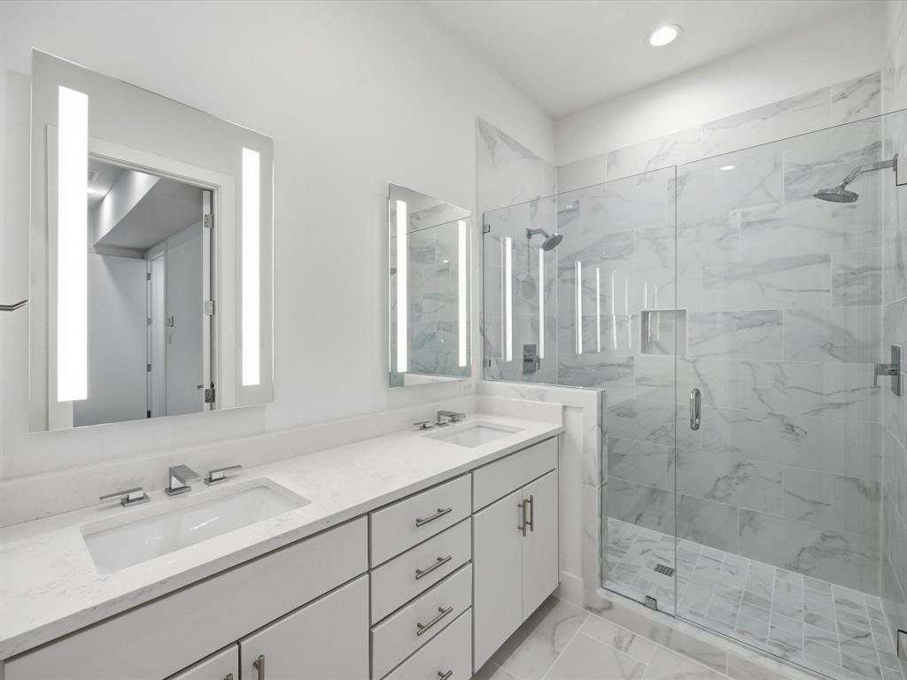 1920 Dowgate Court Dallas, TX 75204 - Photo 9 of 38 Bathroom featuring double vanity, a marble finish shower, and recessed lighting
