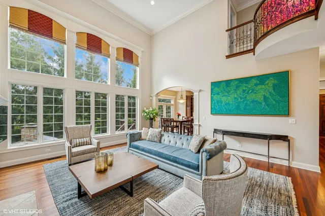 a living room with fireplace furniture and a floor to ceiling window