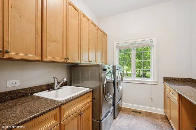 a utility room with a sink a washer and dryer