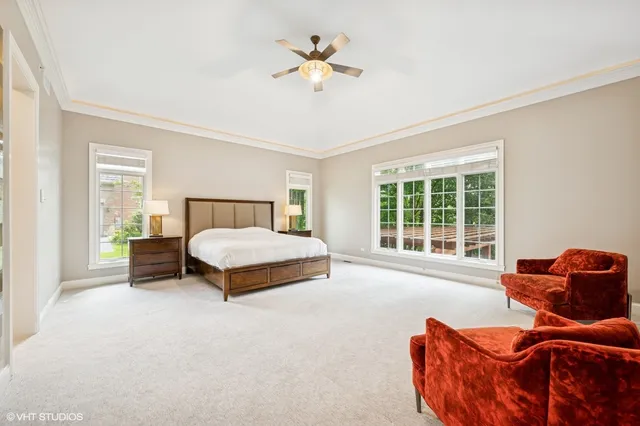 a bedroom with furniture and a large window