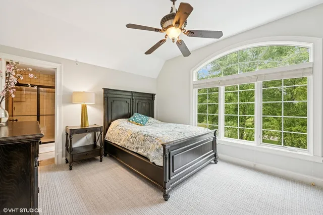 a bed sitting in a room next to a window