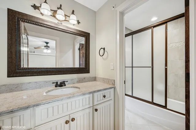 a bathroom with a sink vanity and a mirror