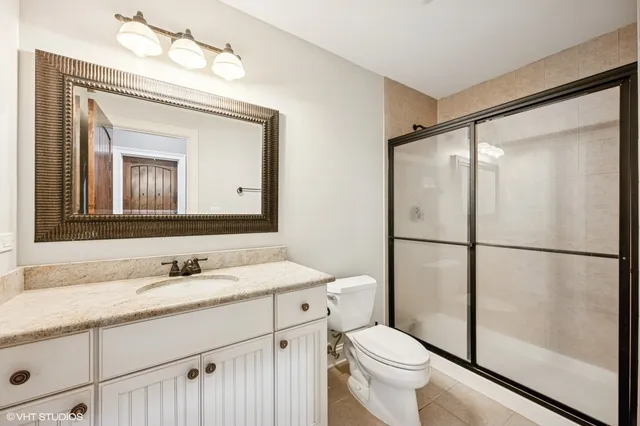 a bathroom with a sink vanity mirror and toilet