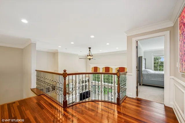 a view of a hallway with wooden floor and furniture