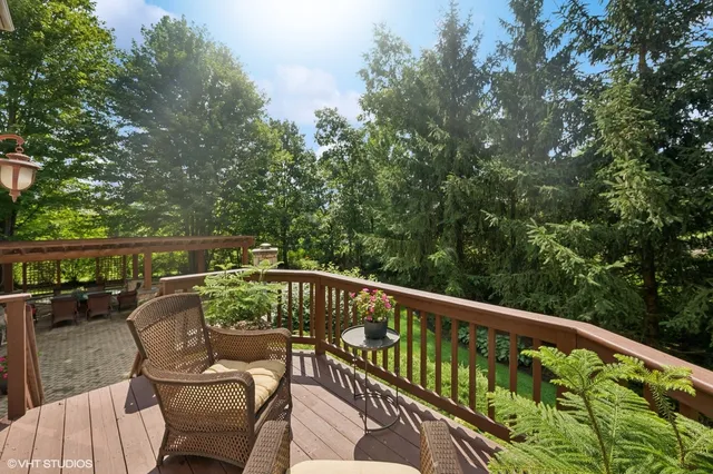 a view of a roof deck with chair and wooden floor