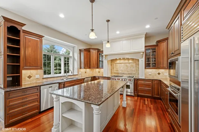 a kitchen with stainless steel appliances granite countertop a stove and refrigerator
