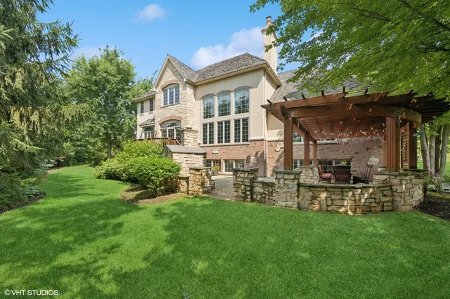 a view of a house with a yard and sitting area