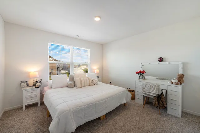 a bedroom with a bed and a window