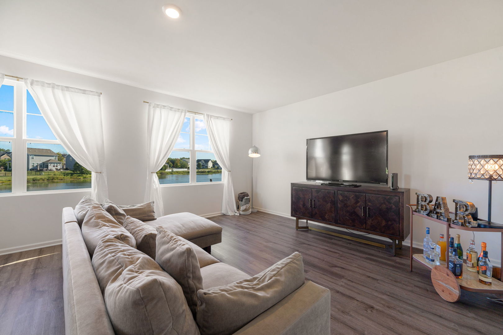 2042 Legacy Pointe Boulevard Plainfield, IL 60586 - Photo 10 of 20 a living room with furniture and a flat screen tv