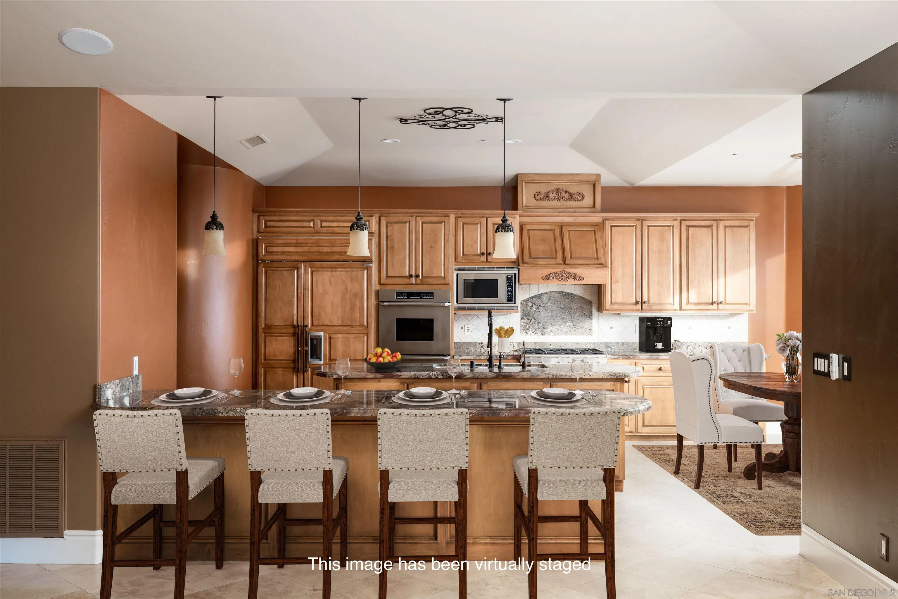 14755 High Valley Road Poway, CA 92064 - Photo 12 of 59 a dining hall with stainless steel appliances kitchen island granite countertop a table chairs and a refrigerator