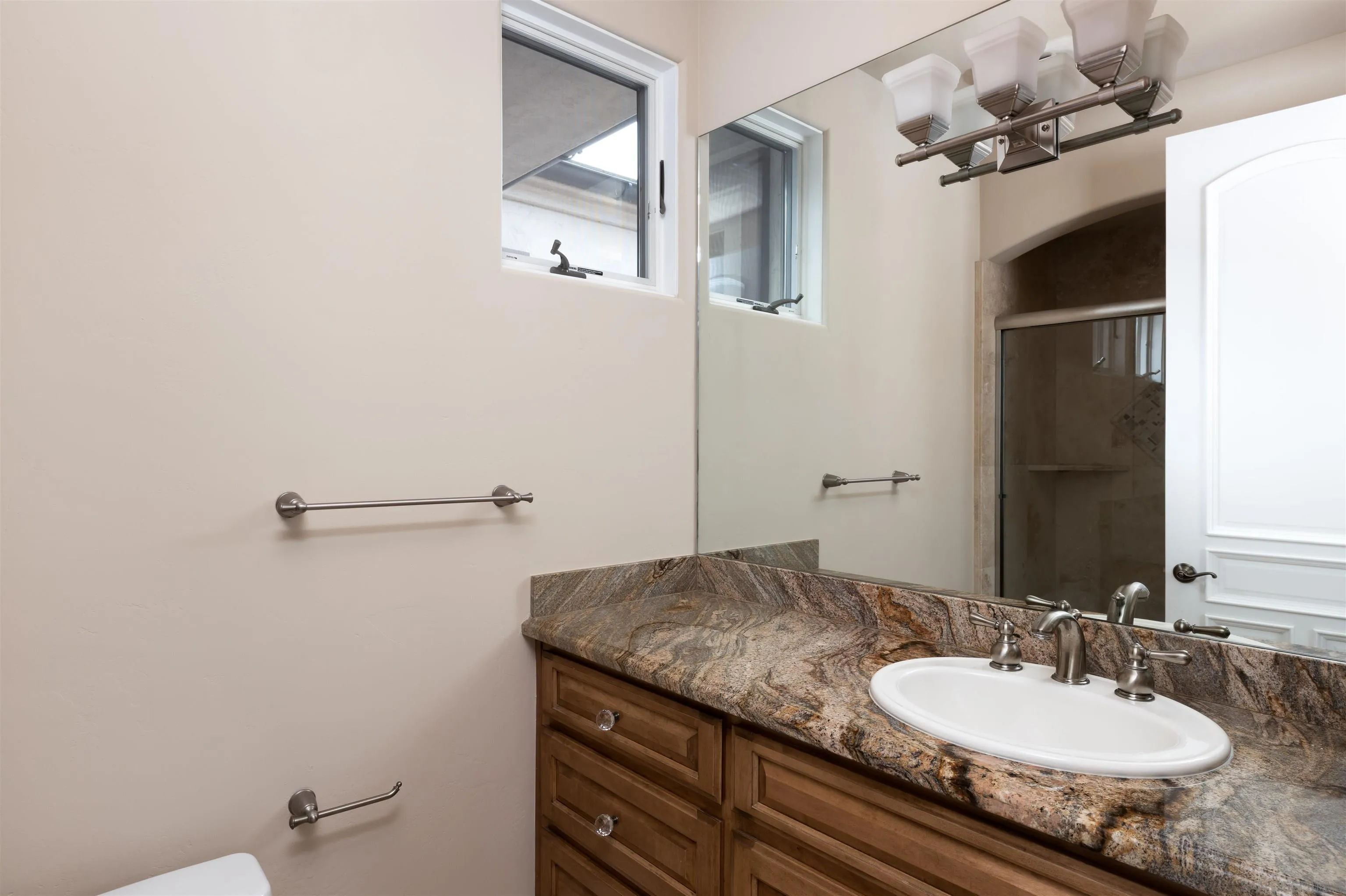 14755 High Valley Road Poway, CA 92064 - Photo 25 of 59 a bathroom with a granite countertop sink and a mirror