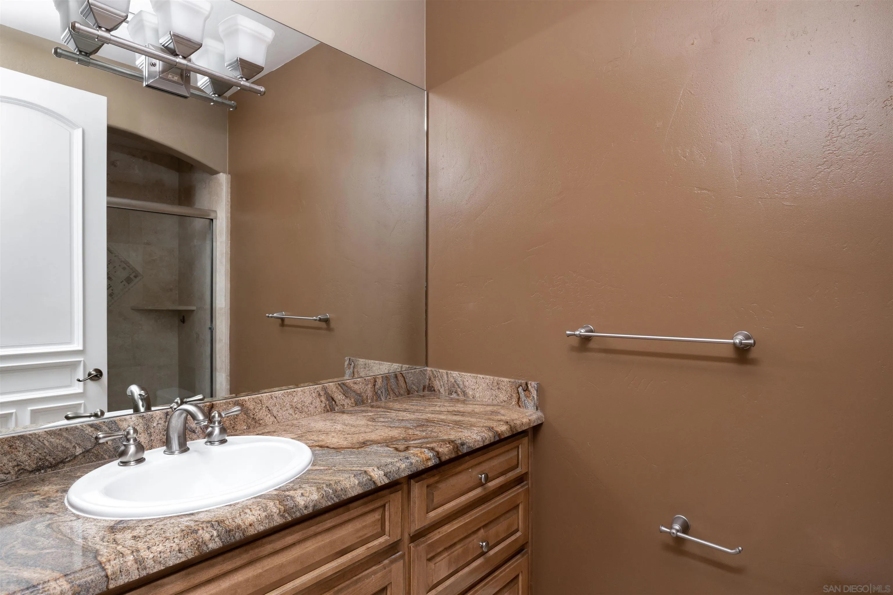 14755 High Valley Road Poway, CA 92064 - Photo 30 of 59 a bathroom with a granite countertop sink and a mirror