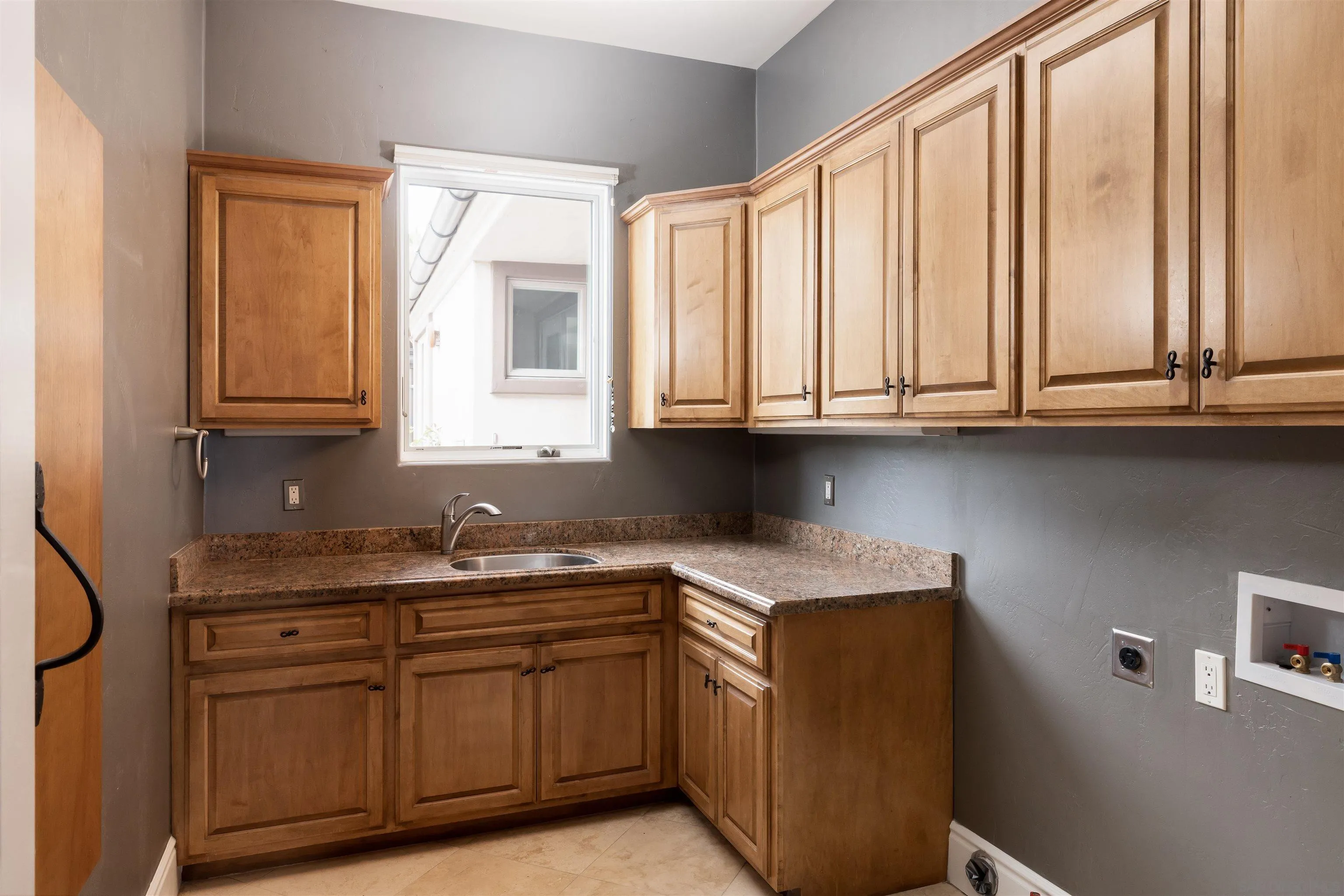 14755 High Valley Road Poway, CA 92064 - Photo 33 of 59 a kitchen with stainless steel appliances granite countertop a sink and cabinets with wooden floor