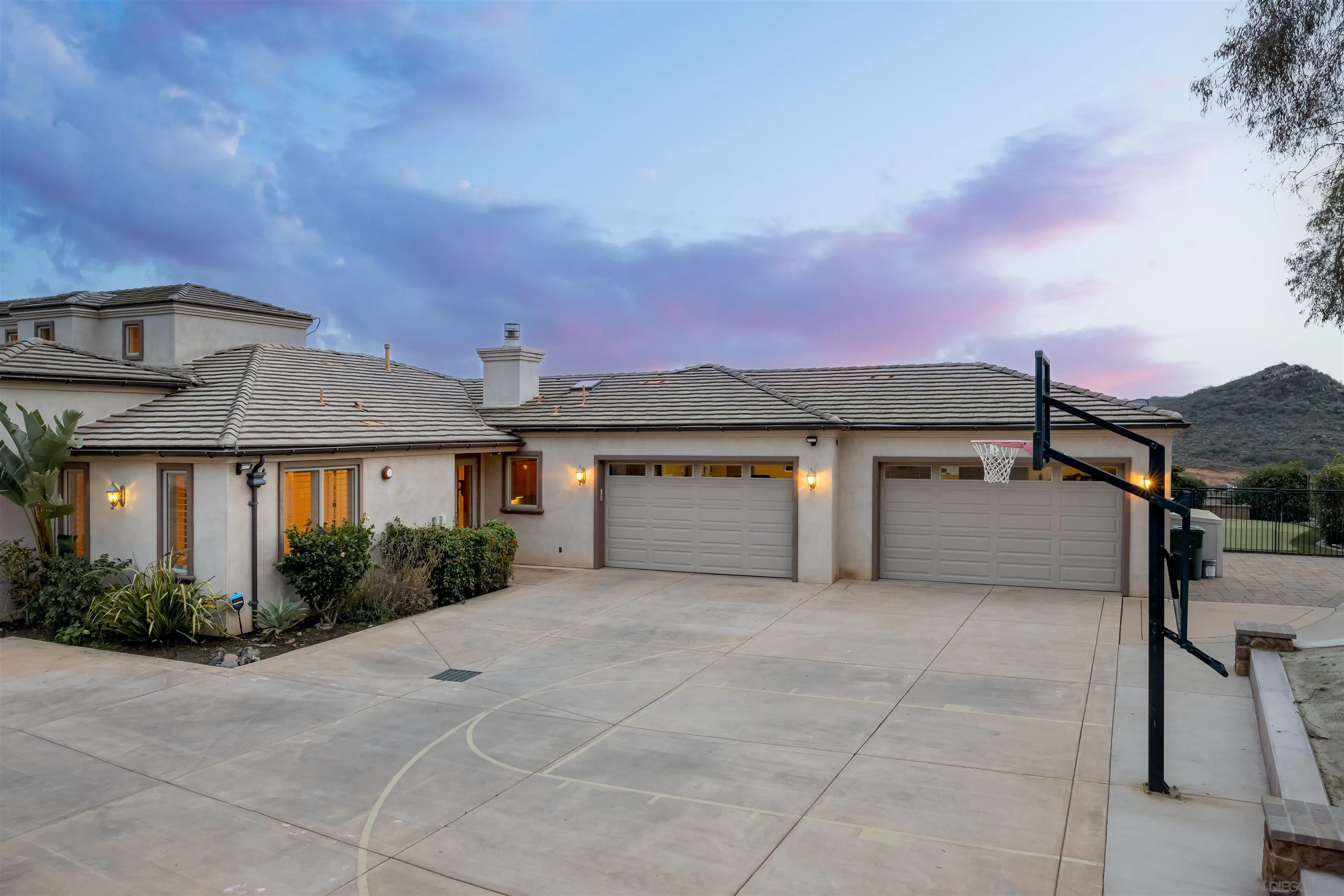 14755 High Valley Road Poway, CA 92064 - Photo 47 of 59 a front view of a house with a yard and garage