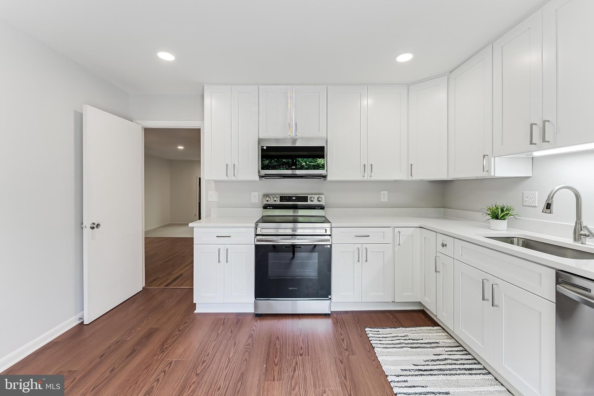 12023 Insha Court Reston, VA 20191 - Photo 21 of 52 a kitchen with granite countertop a stove and a sink