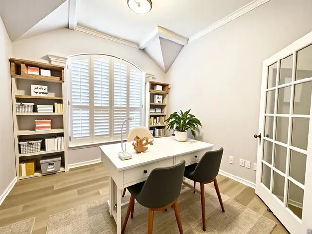 a dining room with a table and chairs