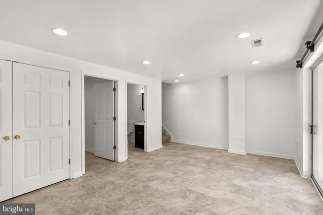 an empty room with closet area