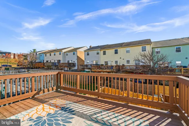 a view of a roof deck with wooden floor and fence