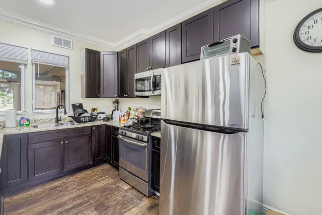 a kitchen with stainless steel appliances a refrigerator sink and cabinets