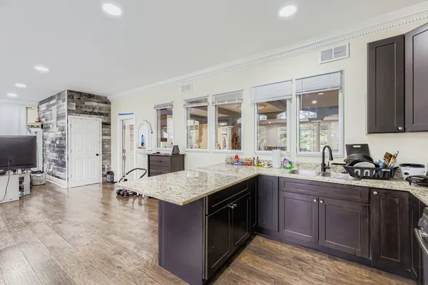a kitchen with a sink a stove and chairs