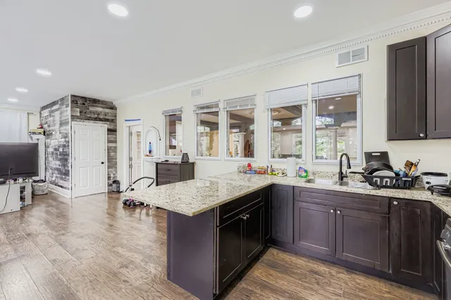 a kitchen with a sink a stove and chairs