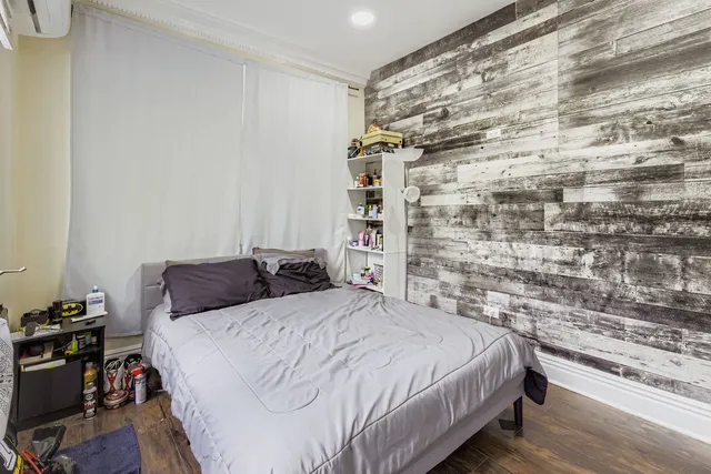 a bedroom with a bed and a bookshelf