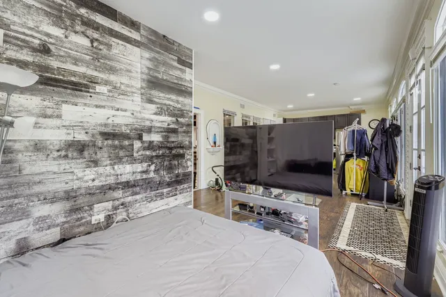 a bedroom with a bed and a flat screen tv