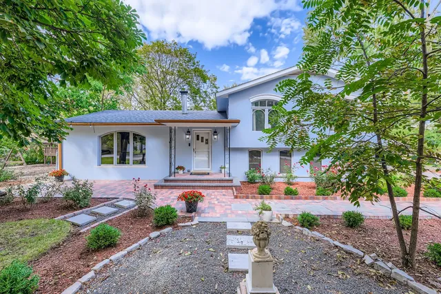 a front view of a house with garden
