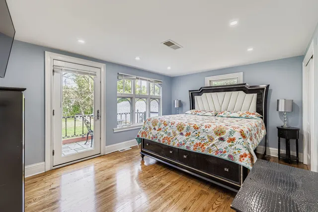 a large bed sitting in a bedroom next to a window