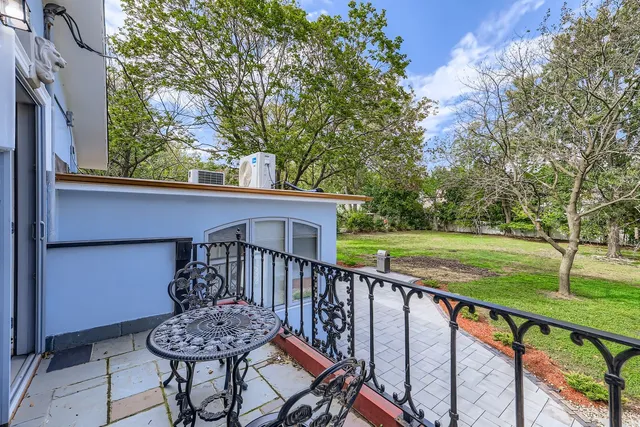 a view of a deck with a table and chairs with wooden floor and fence
