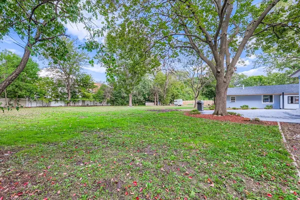a view of a house with yard and tree s